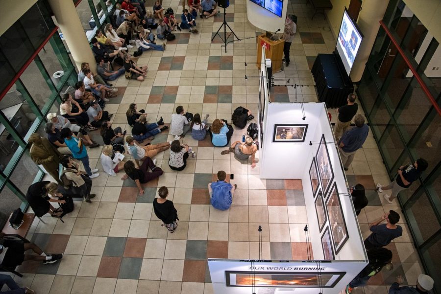 Students and faculty attend the opening of “Our World Burning,” a photo exhibition featuring a curation of work from the visual journalists who covered the California wildfires in Jody Richards Hall on Tuesday, Sept. 24, 2019.