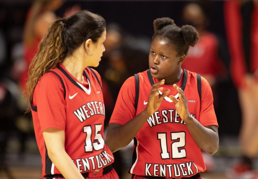 Western Kentucky University Lady Topper Fatou Pouye (12) communicates the game plan to Raneem Elgedawy (15).