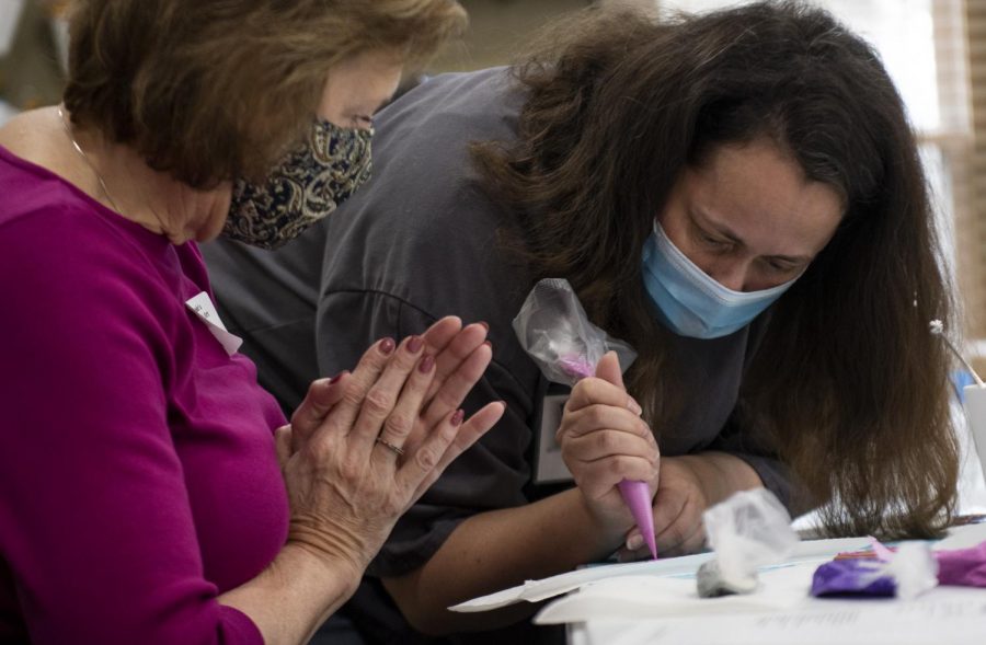 Tunde Dugantsi demonstrates a piping technique to Marlene Walstra during the cookie decorating class on Feb. 13, 2021. Dugantsi’s monthly classes are for any skill level.