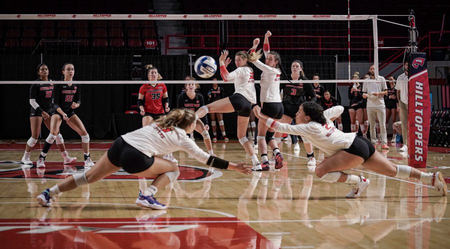 WKU Hilltoppers' fifth-year defensive specialist Logan Kael (18) and fifth-year setter Nadia Dieudonne (2) dive for a missed block during a volleyball match in Diddle Arena, against the Austin Peay Governors on Friday evening, Sept. 17, 2021.