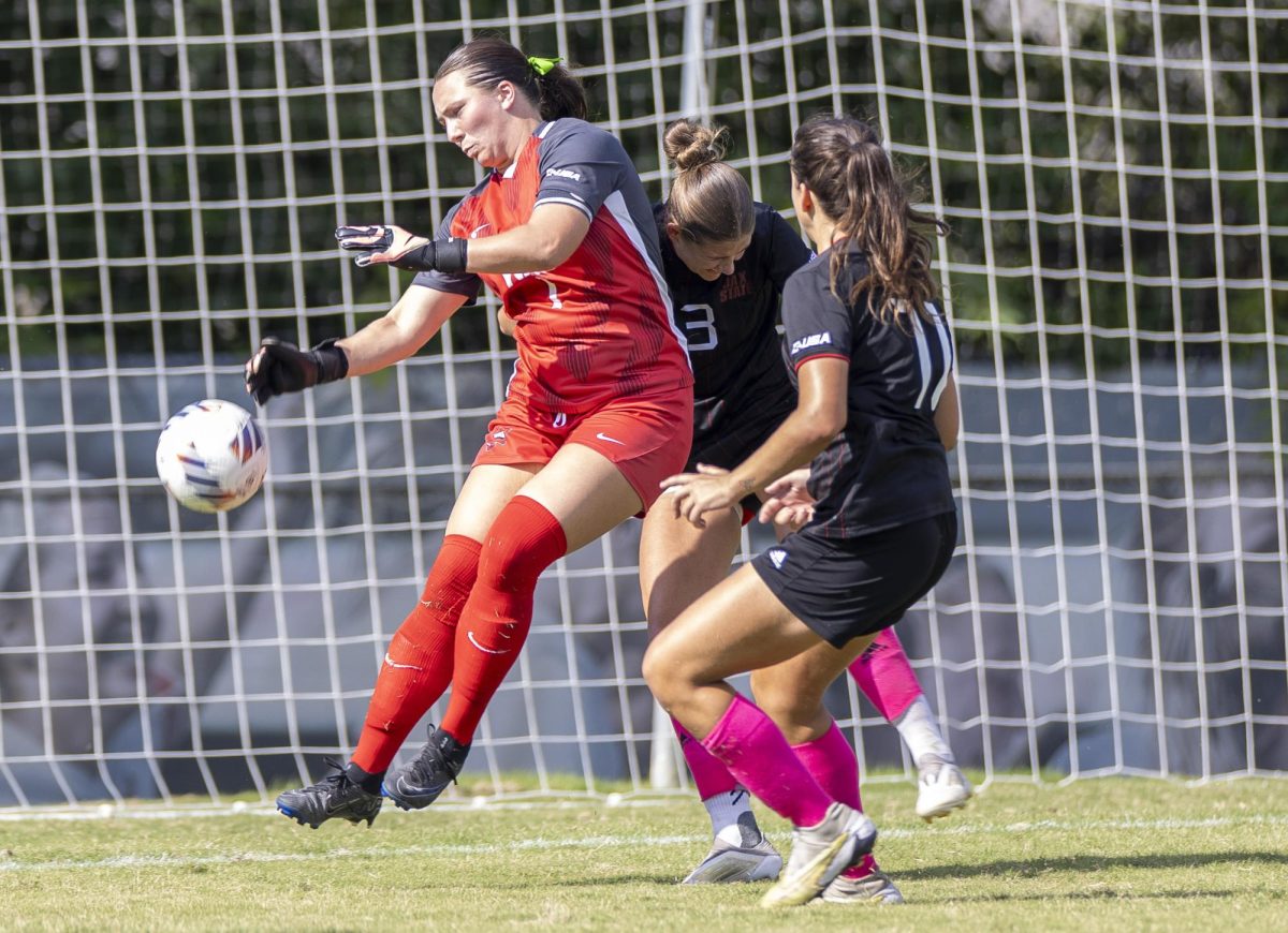 Western Kentucky University goalkeeper Maddie Davis (1) is pushed by her opponent after blocking a ball from going in the goal during a match against Jacksonville State University at the WKU Soccer Complex on Sunday, Oct. 6, 2024.  
