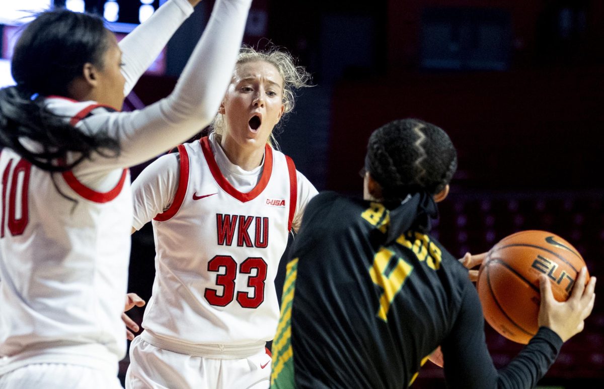 WKU center Josie Gilvin (33) try’s to distract KSU’s Diara Williams (4) from passing the ball during WKU’s win against Kentucky State University 104-49 in Diddle Arena on Saturday, Nov. 9, 2024. 