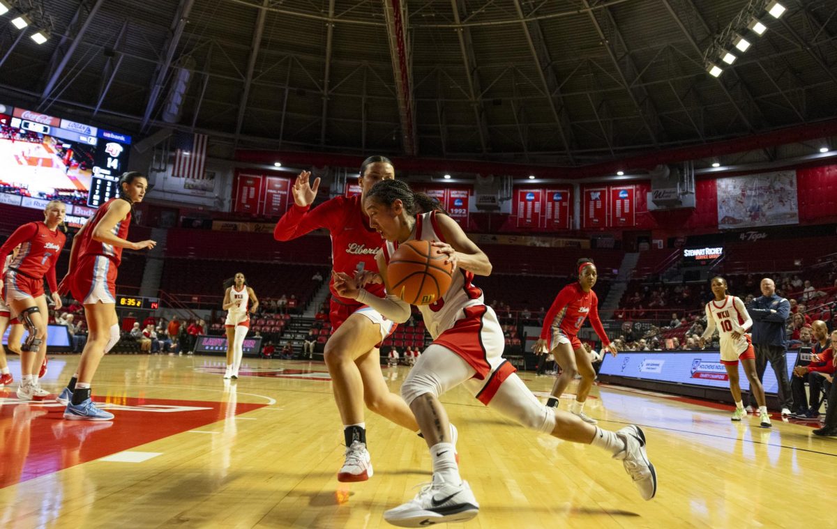 WKU guard Alexis Mead (3) fights with a defender during the Lady Topper's game against the Liberty Flames in Bowling Green, Ky. on Thursday, Jan. 2, 2025.