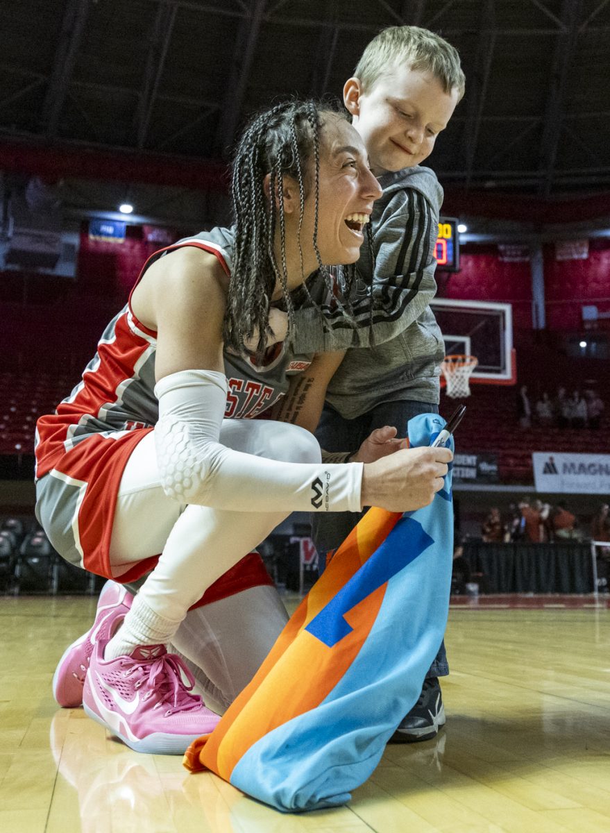 Western Kentucky Lady Toppers guard Alexis Mead (3) is hugged by Kaiser Downs after signing a jersey after a game against University of Texas El Paso at Diddle Arena on Thursday, Feb. 27, 2025.