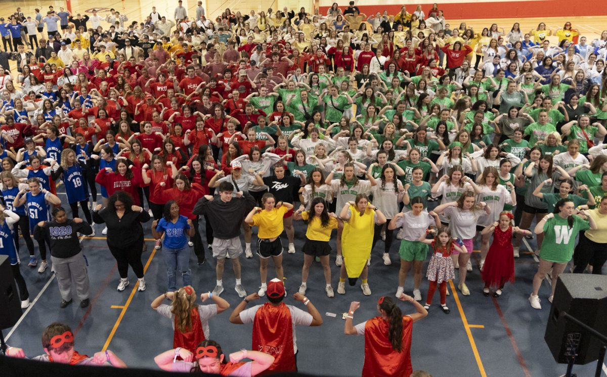 Dance Big red participants flex their arms as they learn the 2025 dance during the annual DBR event in Preston Center at Western Kentucky University to raise money for Norton Children’s Hospital on March 7, 2025.