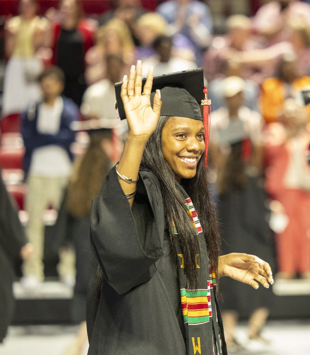 A Potter College of Arts and Letters Graduate waves at her family during the PCAL recognition ceremony on Friday, May 9, 2025.