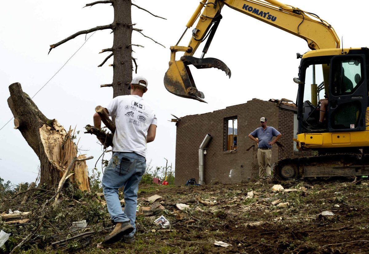 Members of Seth Swafford’s construction company from Manchester, Ky. work to clear damaged trees from Friday’s EF-4 tornado in the Sunshine Hills community of London, Ky. on May 19, 2025. Swafford (rear right standing) is part of a wave of contractors and construction workers who poured into Laurel County to provide cleanup and repair for the community throughout the weekend.